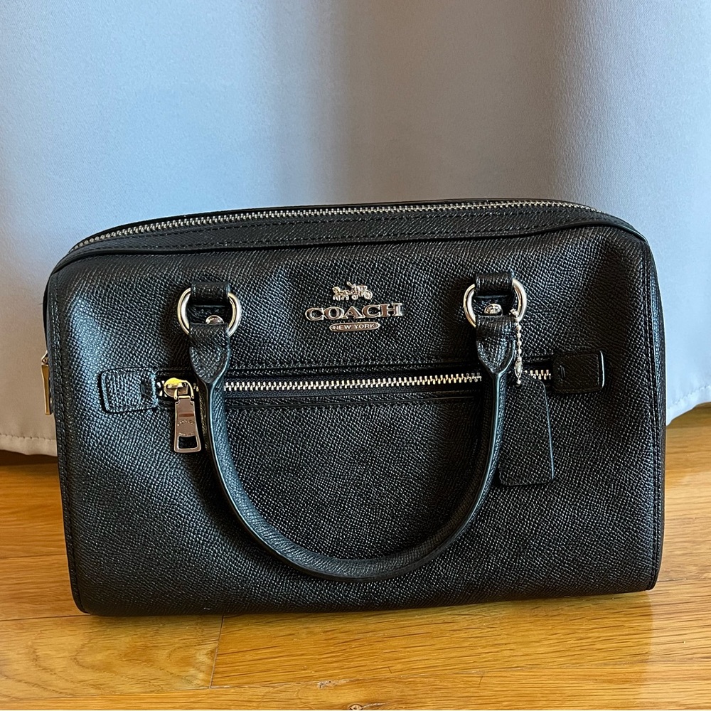 Black leather COACH satchel.